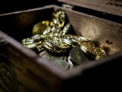 A vibrant graphic showing a treasure chest overflowing with coins and gems.